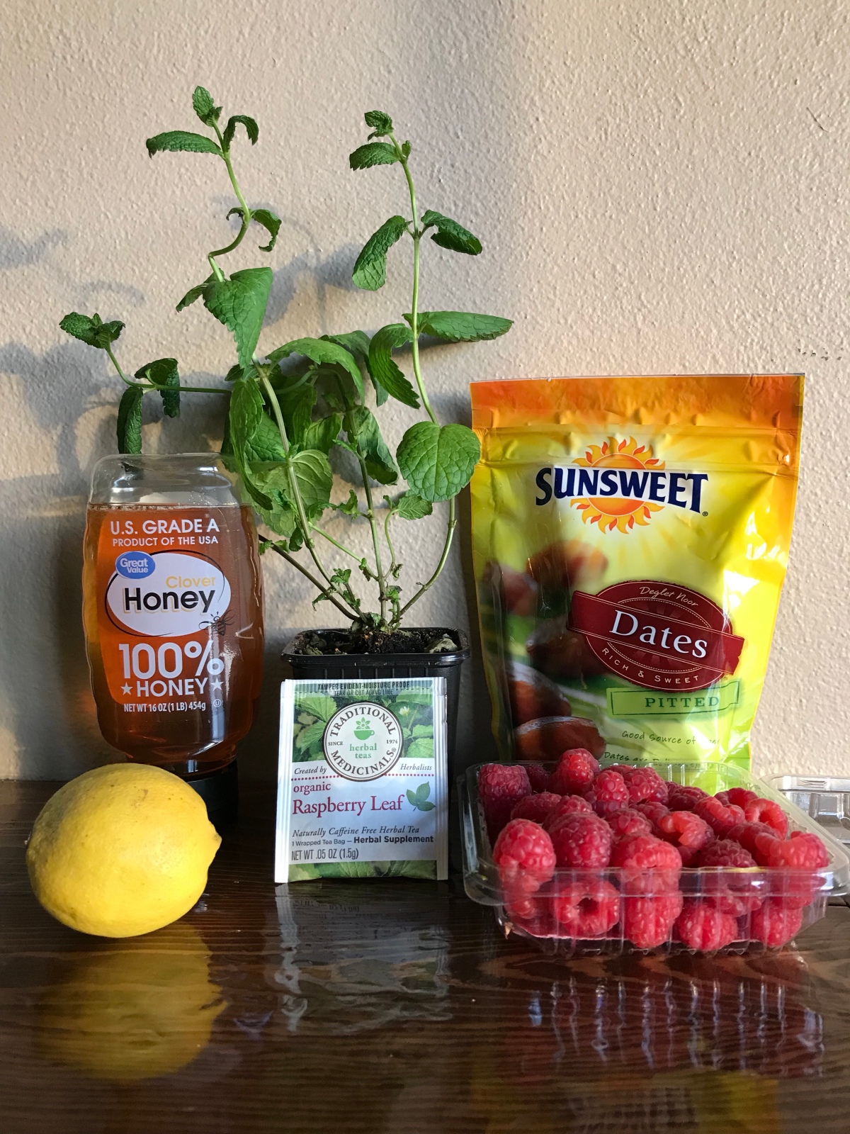 Ingredients in a Third Trimester Mocktail: Dates, Red Raspberry Leaf Tea, Spearmint Leaves, Lemon, Raspberries, And Honey